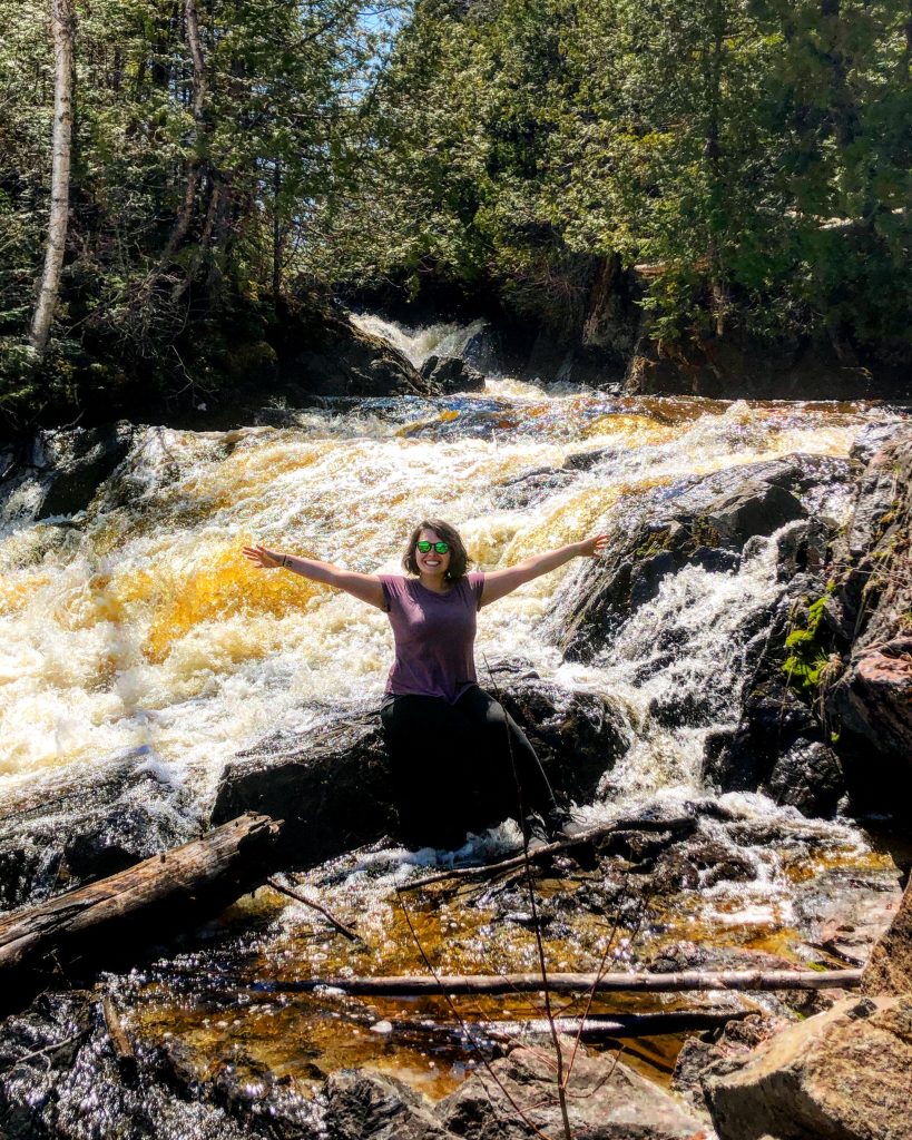 Feeling Good Natured Woman standing in the water at The Jumbo Cove in Orient Bay, Ontario