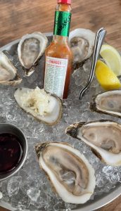 six oysters with hot sauce