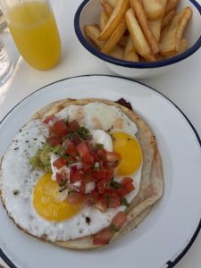a breakfast of huevos rancheros and fries