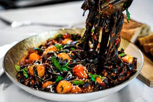 Tomato confit and squid ink pasta
